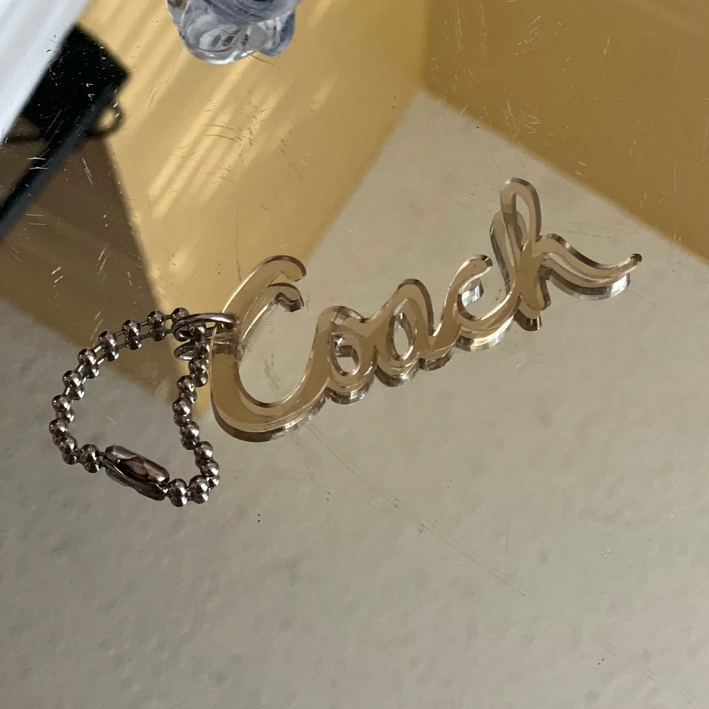 Coach poppy Y2K clear Metallic Gold Script Keychain or bag tag